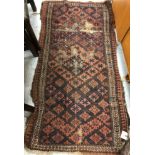 A collection of four vintage tribal rugs varying designs approximately 118 cm x 62 cm,