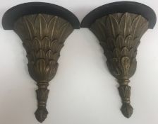 A pair of cast metal wall brackets with stylised leaf decoration,