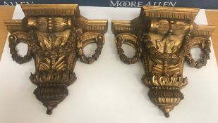 A pair of gilded wood wall brackets in the Classical manner with floral inscribed decoration,