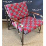 A mid to late 20th Century chrome framed open arm chair with walnut arm rests and red/blue and