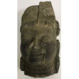 A carved stone Indonesian head 33 cm high