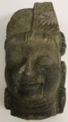 A carved stone Indonesian head 33 cm high