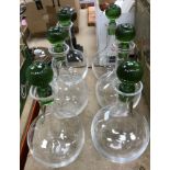 A set of six late 20th Century clear glass Murano decanters with green glass ribbed stoppers,