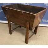 A 19th Century elm dough bin of typical form with canted sides on chamfered supports united by