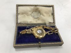 An 18 carat gold cased ladies "Half Hunter" type wristwatch,