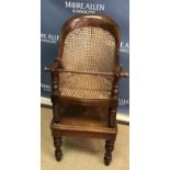 A Victorian mahogany framed child's bergère high chair on stand with baluster turned legs to peg