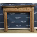 A 20th Century pitch pine fire surround with applied gesso type decoration of love birds and floral