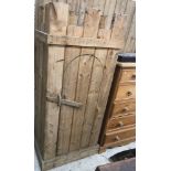 A modern pine wardrobe in the Medieval style with castellated top over a domed door with simple