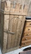 A modern pine wardrobe in the Medieval style with castellated top over a domed door with simple