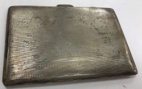 A silver cigarette case with engine turned decoration bearing initials HH inscribed to the interior