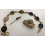 A 14 carat gold mounted hardstone bead bracelet with engraved beetle/scarab style decoration on