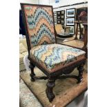 A circa 1900 carved walnut framed hall chair in the Gothic Revival style,