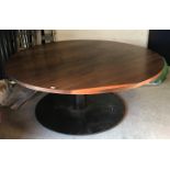 A modern walnut circular dining table,