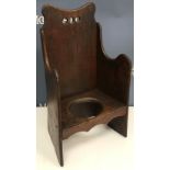 A 19th Century Welsh child's commode arm chair with shaped back and arms, 32.5 cm wide x 58.