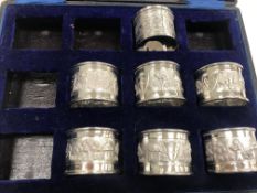 A set of six 20th Century Burmese white metal napkin rings decorated with figures and thatched