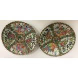 A box containing a pair of Chinese famille rose plates with scalloped edges,