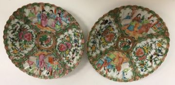 A box containing a pair of Chinese famille rose plates with scalloped edges,