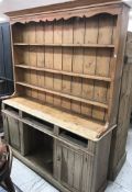 A pine dresser, the boarded three tier plate rack over three drawers (drawers themselves missing),