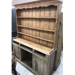 A pine dresser, the boarded three tier plate rack over three drawers (drawers themselves missing),