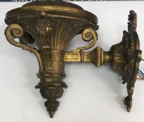 A gilt metal wall lamp with acanthus leaf decoration later converted to electric 28 cm deep x 21.