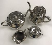 A silver / white metal four piece tea set of squat pear form, comprising teapot, water jug,