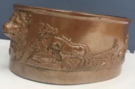 A stoneware oval game pie dish with agricultural ploughing scene in relief,