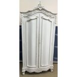 A modern white painted armoire in the Louis XV taste with foliate and floral carved decoration,