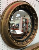 A 19th Century circular gilt framed wall mirror with ball decoration and convex glass,