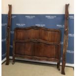 A 20th Century French walnut bedstead in the Louis XV provincial manner,