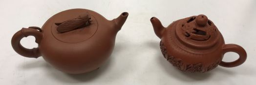 A 20th Century Chinese Yi Xing pottery teapot, the lid set with cicada handle,