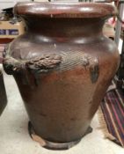A large treacle glazed stoneware wheatsheaf decorated floor vase,