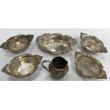 A set of four pierced and embossed sterling silver oval sweetmeat dishes 9.6 cm x 6.4 cm x 2.