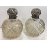 A pair of Edwardian hobnail cut glass grenade scent bottles with embossed silver mounts (by James