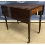 A 19th Century mahogany drop-leaf Pembroke table with single end drawer on turned tapering legs to