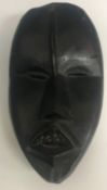 A modern carved “Black” stone mask 21 cm high together with a 20th Century African carved panel