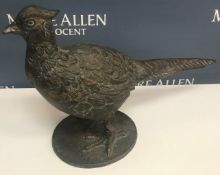 A modern cast metal model of a pheasant on an oval base, 55 cm long x 40.