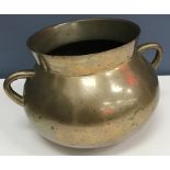 A 19th Century bronze cauldron/cooking pot of rounded bottom form with twin handles 20.