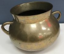 A 19th Century bronze cauldron/cooking pot of rounded bottom form with twin handles 20.