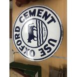 A vintage enamel sign inscribed "Use Oxford Cement" with cow trademark to centre and Barltrop