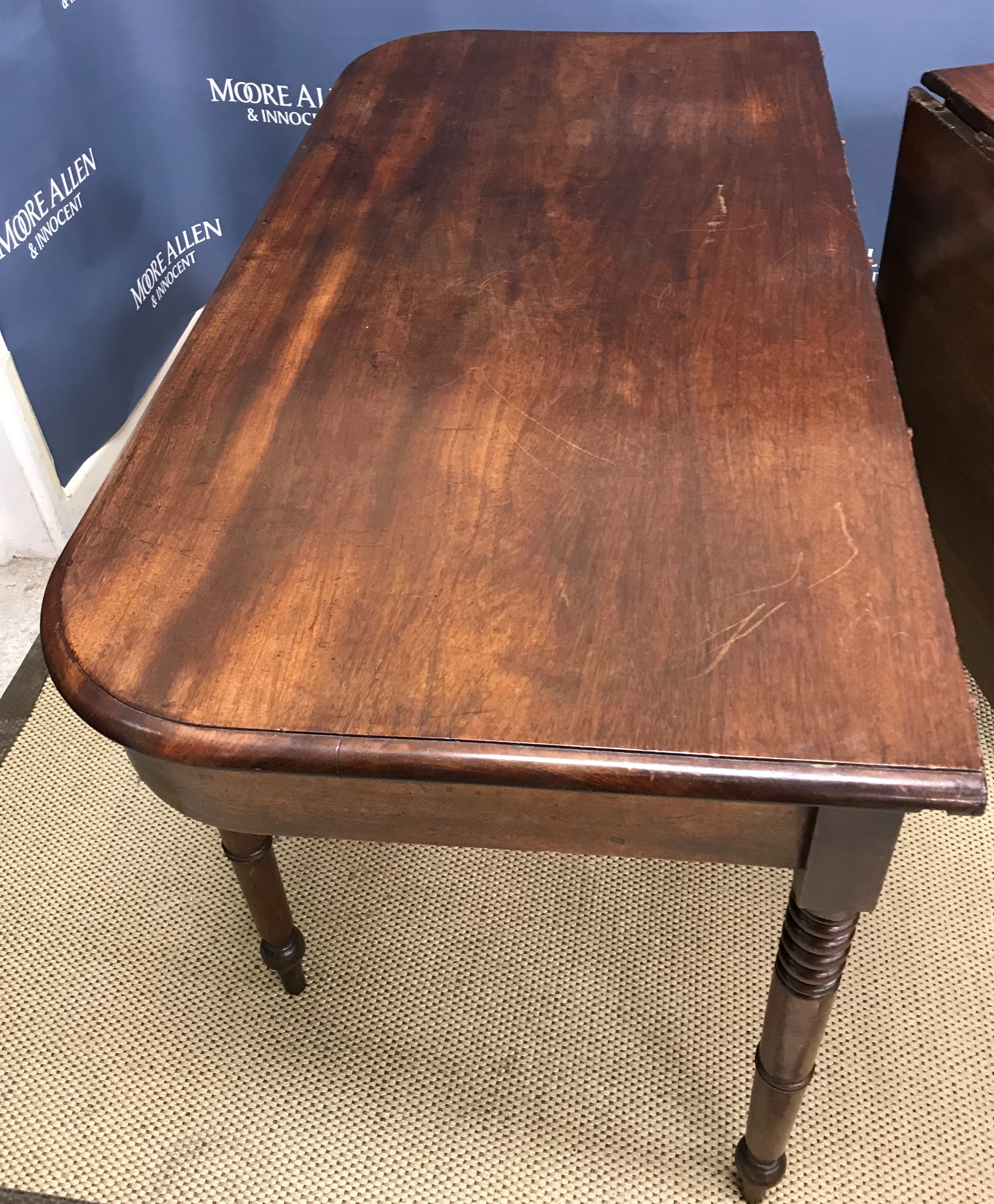 An early 19th Century mahogany single drop-leaf extending dining table,