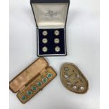 Three cased sets of enamel decorated buttons,