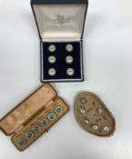 Three cased sets of enamel decorated buttons,