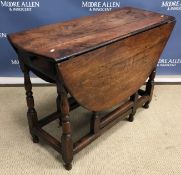 A walnut and oak oval gate-leg drop-leaf dining table in the 18th Century manner,