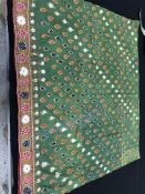 A box containing four lengths of Indian textiles,