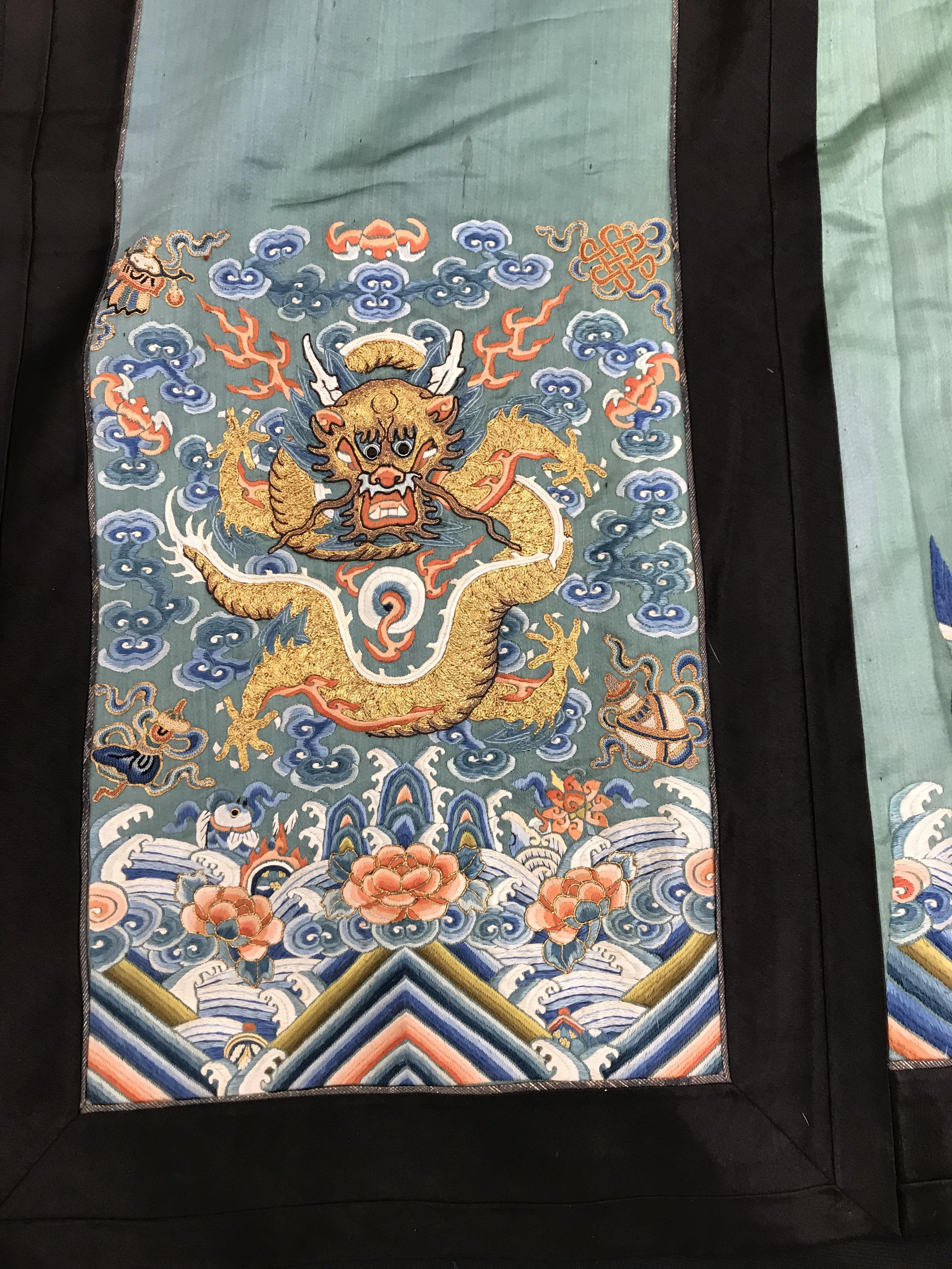 A Chinese teal silk skirt with black borders and a peach waistband, silk panels embroidered in blue, - Image 5 of 69
