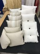 Three boxes of mainly neutral coloured cushions, together with a faux fur throw,