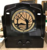 An Art Deco Ekco bakelite radio with pierced tree decoration to the front grill bears label verso