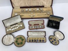 A collection of eight cases of paste buttons, studs and cufflinks, with various mother of pearl,