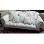 A modern buttoned white leather scroll arm sofa in the Victorian style,