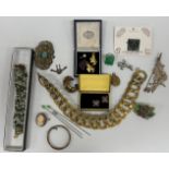 A box of mainly costume jewellery to include a silver brooch as a horse and rider,